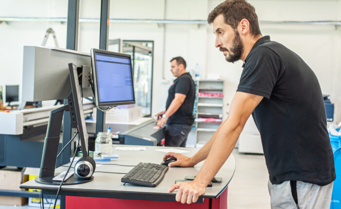 Professional worker printmaker technician operator works in modern printing plant